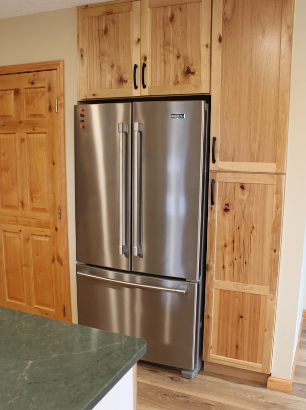 Custom cabinets built around large kitchen refrigerator