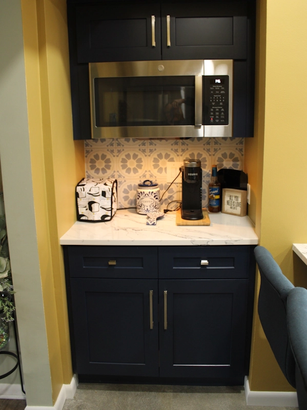 Photo showing custom coffee bar area in new kitchen remodel with microwave above and additional cabinet storage