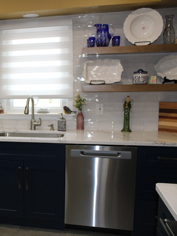 Photo showing kitchen sink and surrounding wall, featuring floating wood shelving