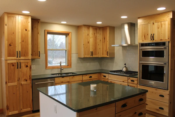Photo showing hickory wood cabinets in newly renovated kitchen, with small custom island in the foreground.